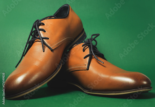 Brown shoes isolated on the green background