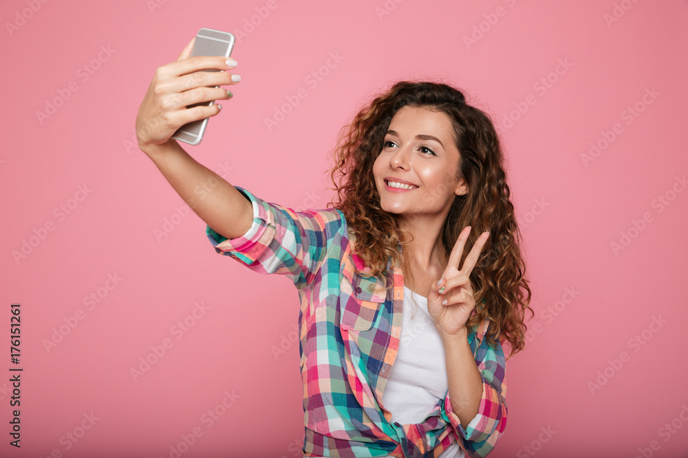 Young beautiful woman making selfie on smartphone isolated Young beautiful woman making selfie on smartphone isolated