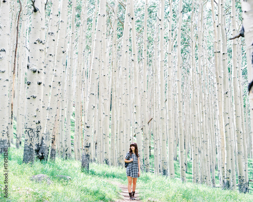 Woman walking in white tree forest