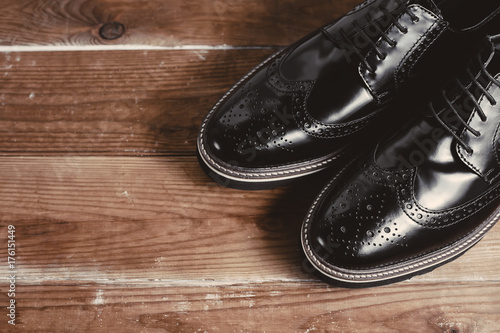 Classic black shoes in wooden background