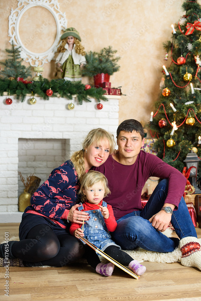 Portrait of friendly family on Christmas evening in the christmas decorated room Portrait of friendly family on Christmas evening in the christmas decorated room