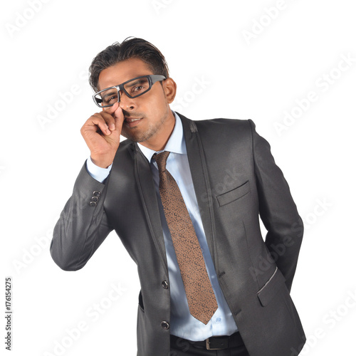 Businessman in black suit funny cleaning nose over white background