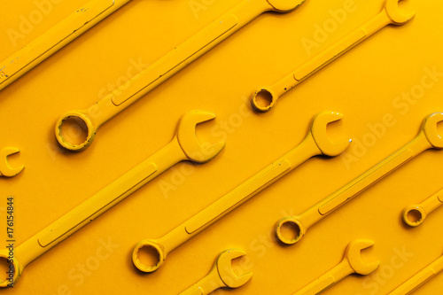 Yellow wrench set on yellow background. photo