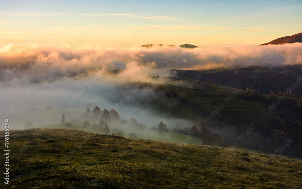 fog rolling over the hills at sunrise. stunning countryside autumnal background fog rolling over the hills at sunrise. stunning countryside autumnal background