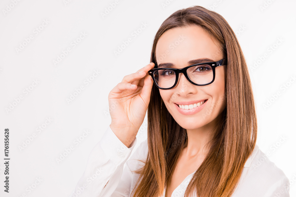 Close up portrait of caucasian gorgeous stunning charming lovely cute expert business lady, on pure white background, grinning, her fingers gently touch black specs
