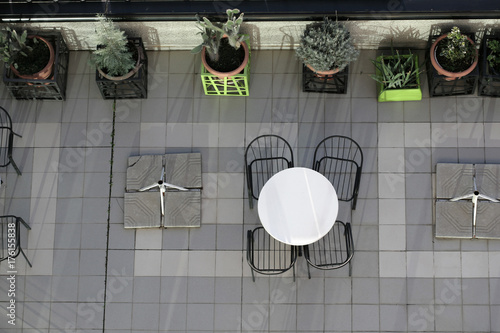 Top view of a metal table with chairs in a hotel terrace.
