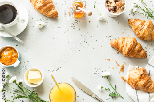 Continental breakfast on stone table from above - flat lay photo