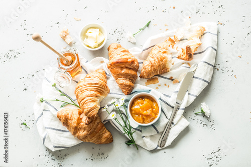 Croissants, jam, honey and butter - continental breakfast