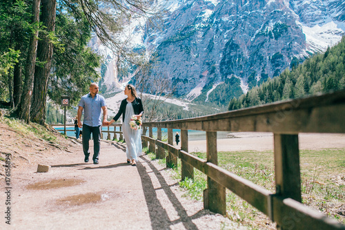 Young Couple against lake, summer park. lago di braies,Dolomite,Italy. Man and woman on vacation in beautiful place.