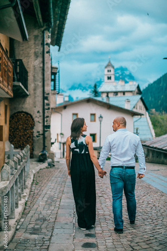 Young couple are walking on an ancient mediterranean street in italy