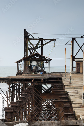 Old rusty pier in Guatemala shot in a cloudy morning. Champerico photo