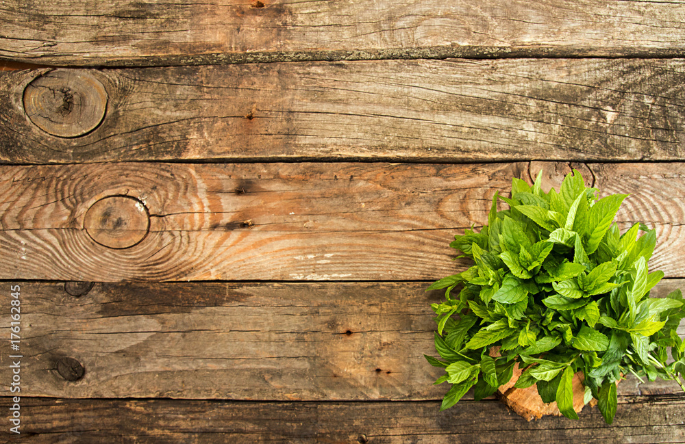 Bundl of mint on old wooden background. Copy space. Top view. Bundl of mint on old wooden background. Copy space. Top view.