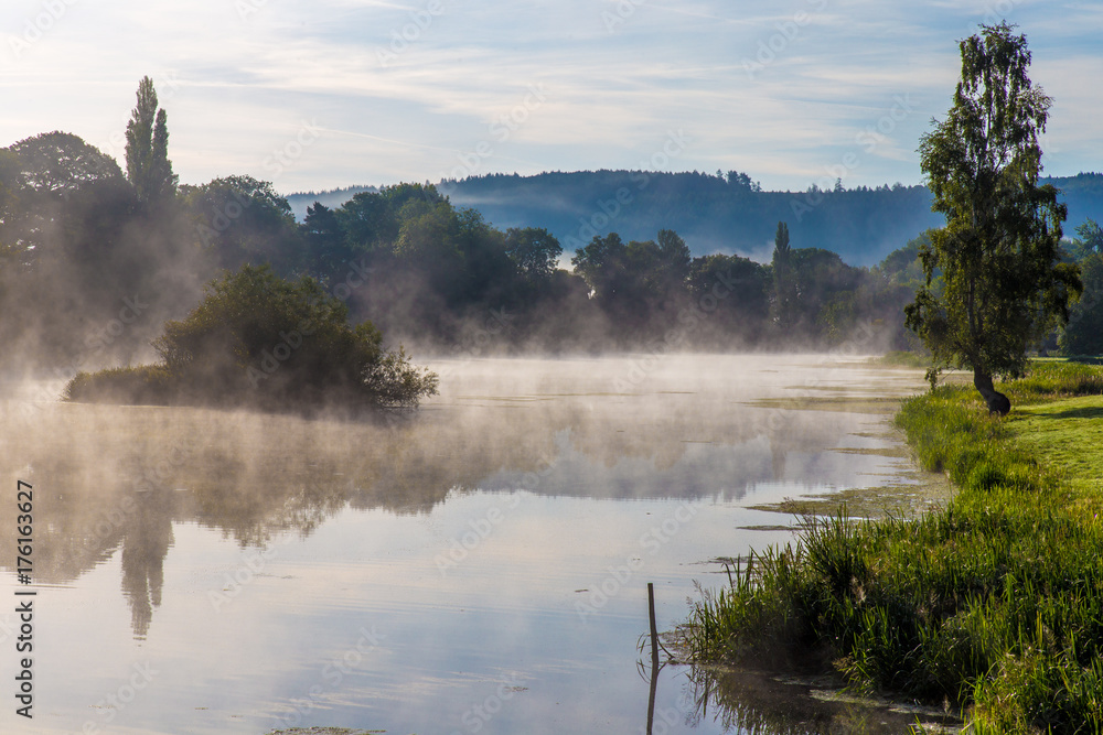 Mist over a lake at sunrise in Shropshire England UK.