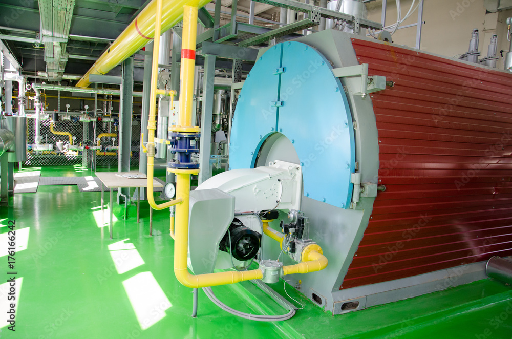The interior of a modern industrial gas boiler room. Pipelines, water pumps, valves, manometers. The interior of a modern industrial gas boiler room. Pipelines, water pumps, valves, manometers.