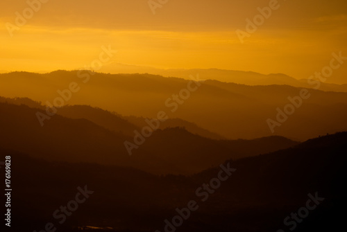 Beautiful orange color mountain range layers during sunset.