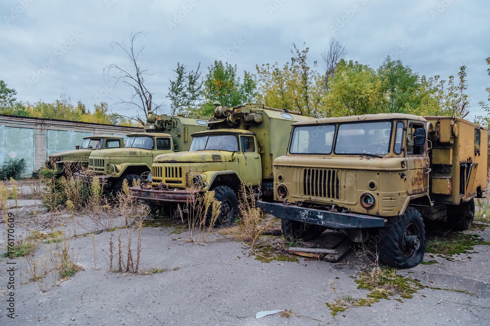 Derelict military trucks in abandoned military base 