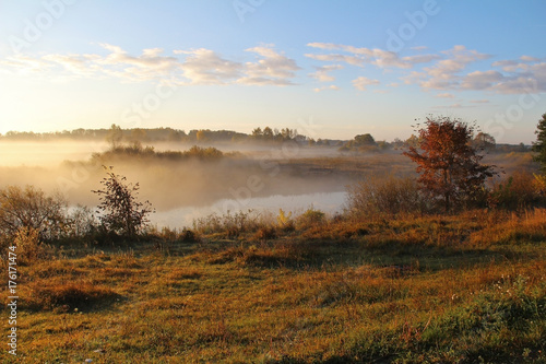 Misty nature landscape on early autumn morning. Russia.