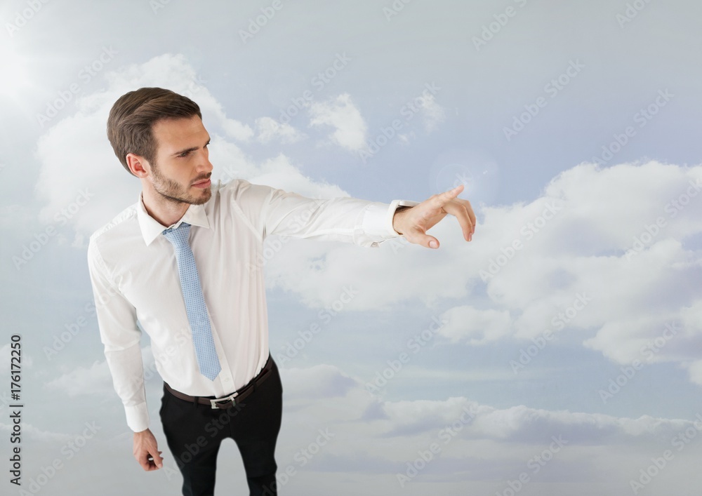 Businessman pointing in clouds Businessman pointing in clouds