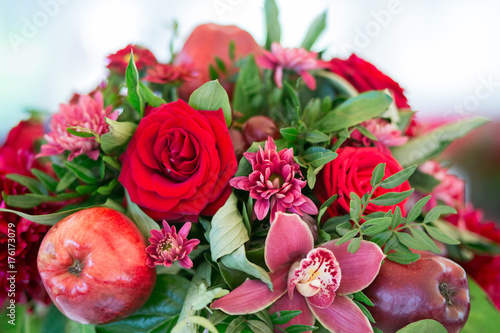 red flowers with decoration and apples, white background