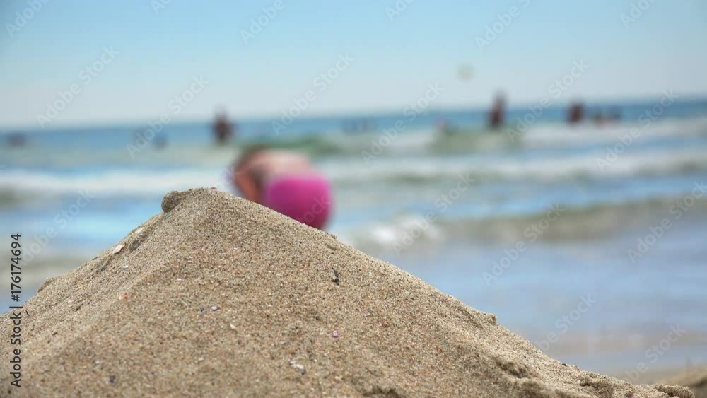 Sand dune on sea beach with dof of child playing Sand dune on sea beach with dof of child playing