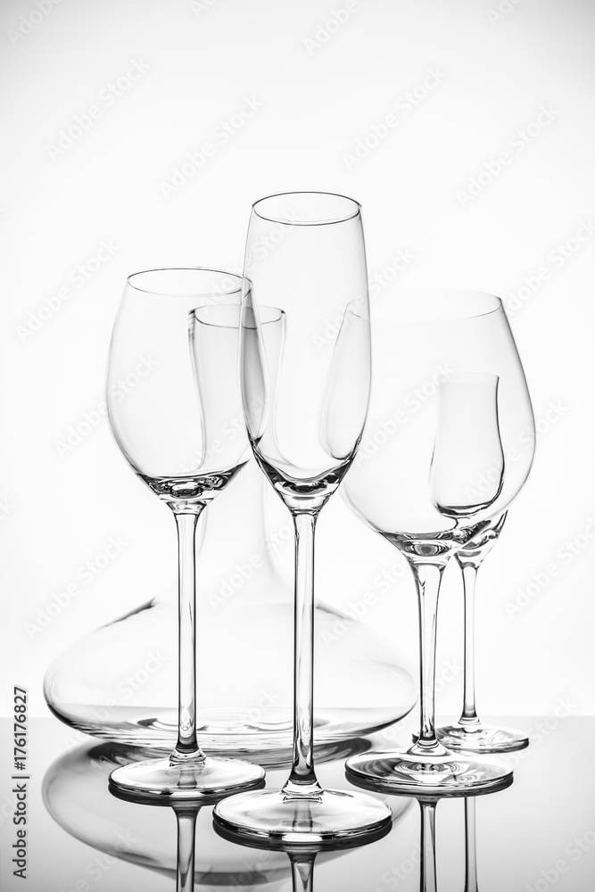 Glassware selection with wine, champagne, liquour glasses and decanter on the light background