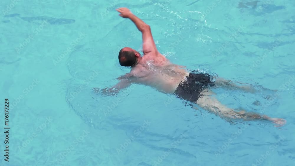 Young man swimming in the swimming pool Young man swimming in the swimming pool