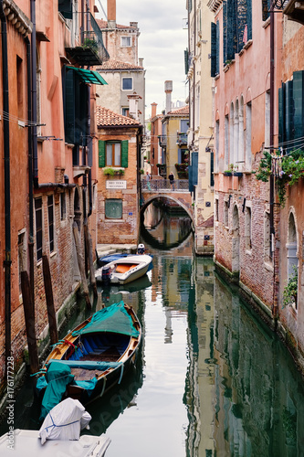 Narrow canal in Venice surrounded by old d buildings