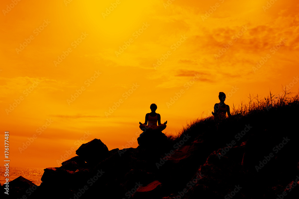 Silhouette women meditation on the hill 