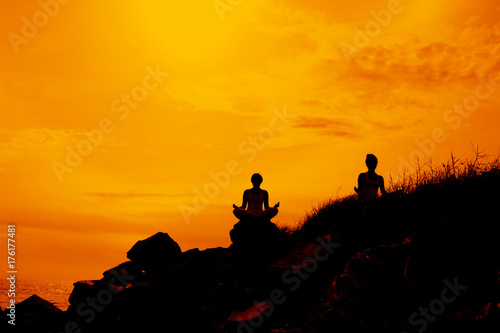 Silhouette women meditation on the hill 