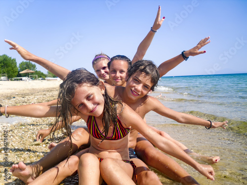 Happy Family with Little Kids Having Fun at the Beach. Joyful Family. Travel and Vacation