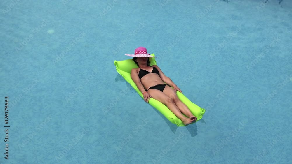 sexy girl floating on a mattress in the sea or sexy girl floating on a mattress in the sea or