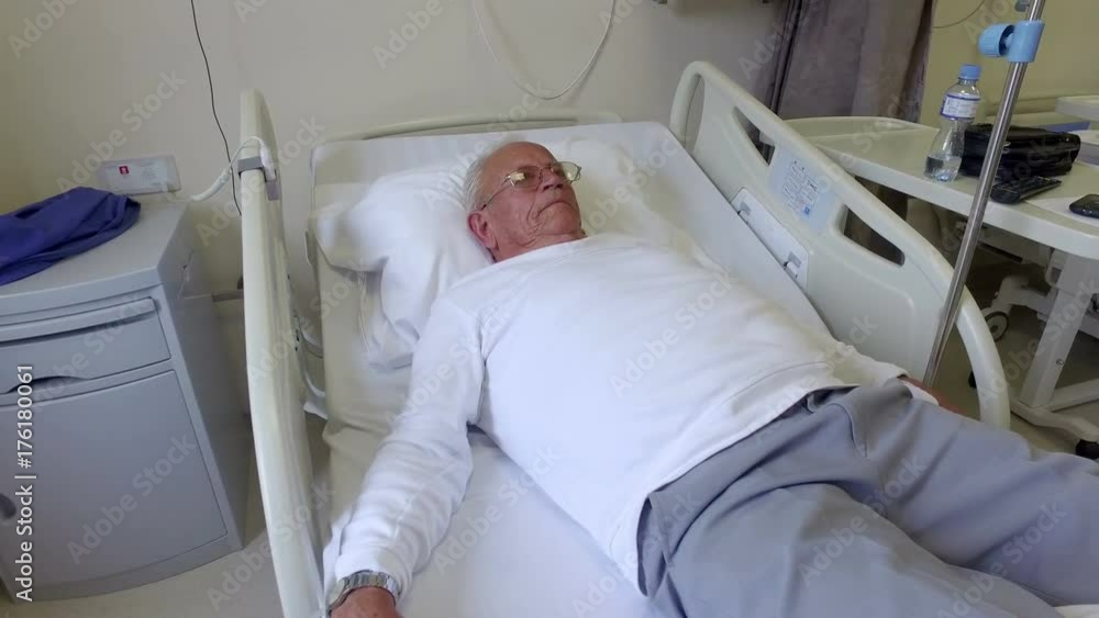 Old man resting in a hospital bed Old man resting in a hospital bed