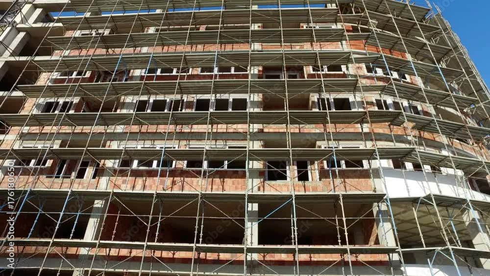 Residental building under construction. Green suburbs. Concrete structure, walls made Residental building under construction. Green suburbs. Concrete structure, walls made