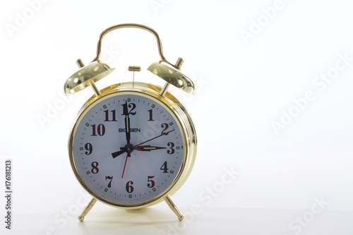 Analog Clock. Gold retro clock on table. Day lights saving. Old fashioned alarm clock. What time is it? Concept of time. Deadline. Layout with copy space for your text. Three o'clock. Time to get go 