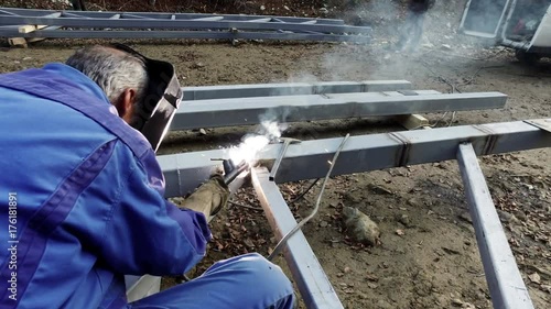 welder, craftsman, erecting technical steel Industrial steel welder in metal 