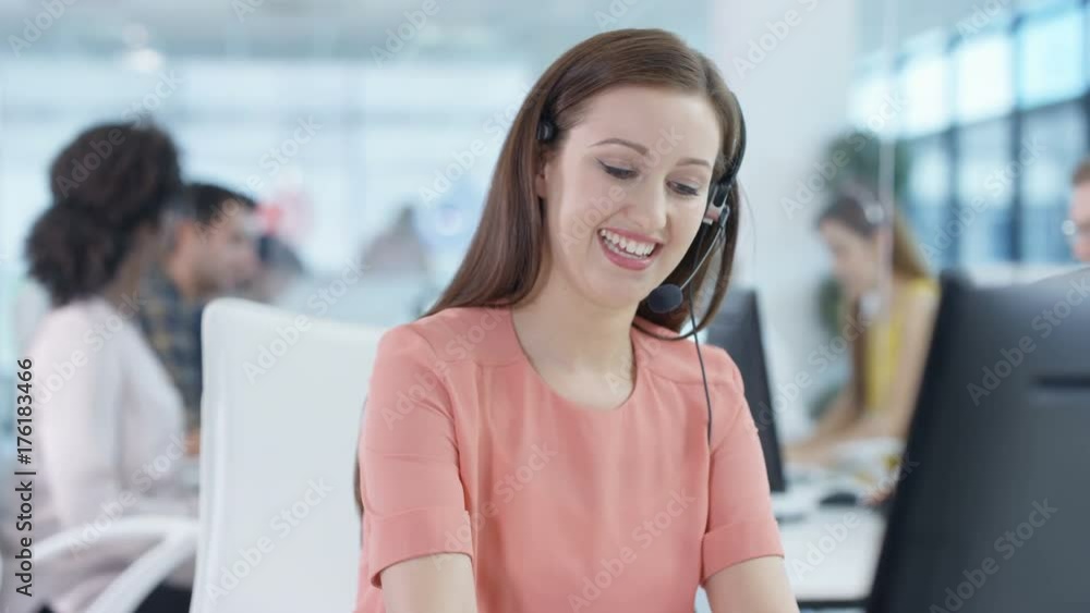 Happy worker in busy call center celebrates making a sale Happy worker in busy call center celebrates making a sale
