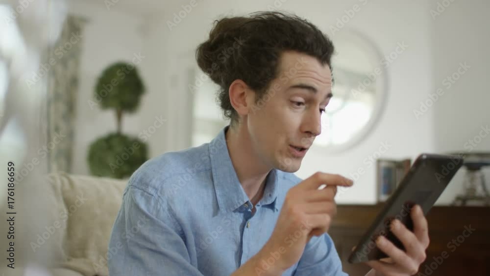 Angry man having argument via video call on computer tablet Angry man having argument via video call on computer tablet