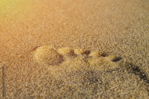 Beach footprint in the sand for relaxing lifestyle concept in bright sun with sand.