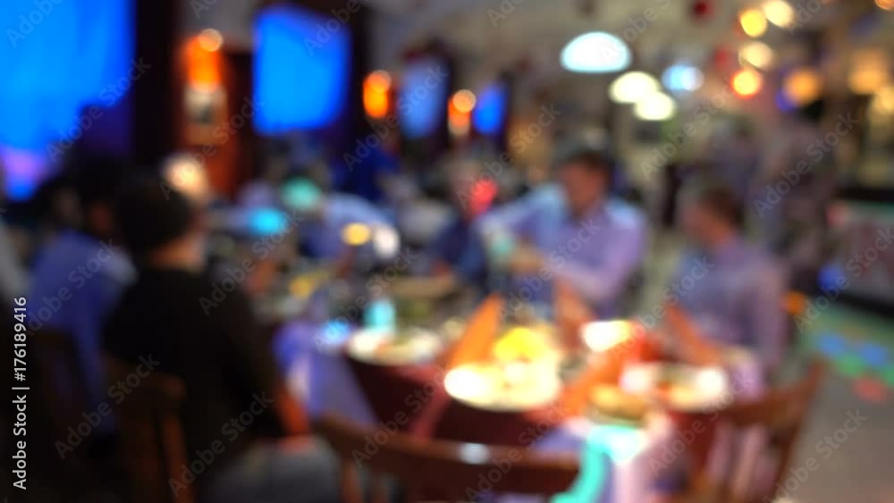 Defocussed people sit at tables in a restaurant. Defocussed people sit at tables in a restaurant.