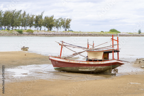 Fishing boats old red run aground