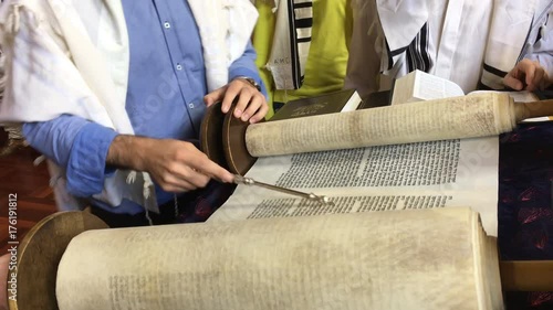 Jewish people reading from the Torah Aliyah Blessings during the High Holidays. Reading the Torah is one of the bases for Jewish life. 