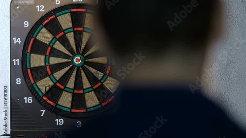 man playing a game of darts, focus on target