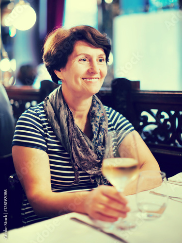 Elderly lonely woman at dinner in restaurant