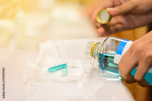 pouring normal alcohol 70% into medical nursing set
