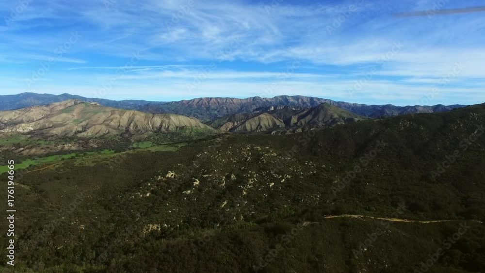 Aerial shot of wide valley with woods and mountains Aerial shot of wide valley with woods and mountains