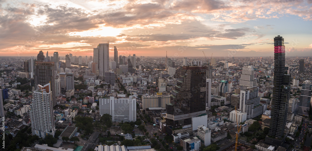 Orange Glow From Sunset Over Silom District, Central Bangkok, Thailand, Aerial Panorama Shot