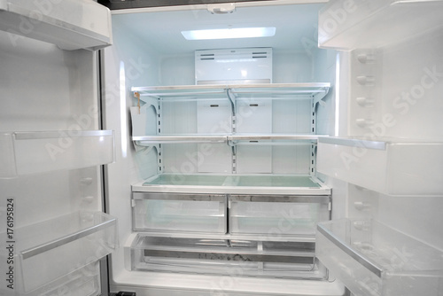 Empty refrigerator with door open