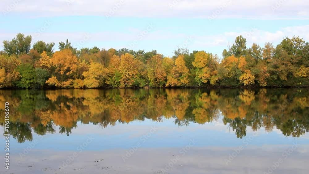 Autumn trees on the island, covered with yellow foliage fascinate by reflection in the water. Autumn trees on the island, covered with yellow foliage fascinate by reflection in the water.