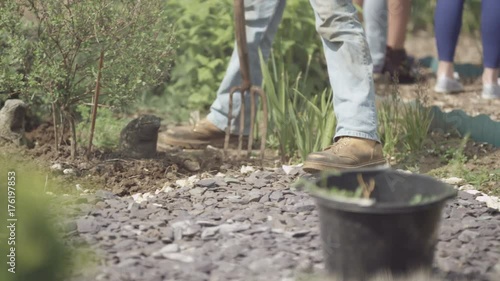 Wallpaper Mural  Man working in community allotment digging soil & planting Torontodigital.ca