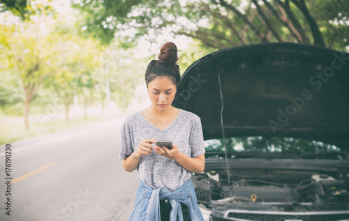 Картината върху платно Asian woman using mobile phone while looking and Stressed man sitting after a ca